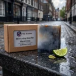 black citrus soap bar on wet stone in a street black citrus soap bar on wet stone in a street