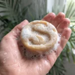 geranium nasd parchouli shampoo bar in a hand